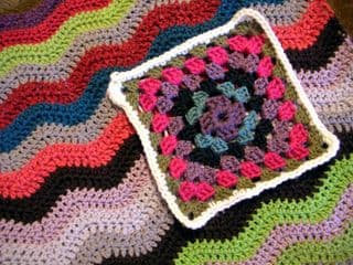Crocheted Granny Square atop Zigzag Afghan