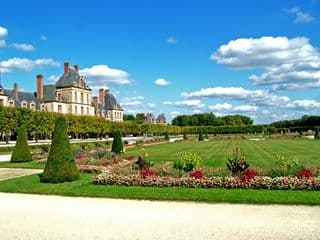 Fontainebleau Castle Gardens Under Blue Skies