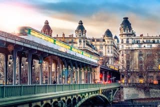 Bridging Paris: A Metro Train Blurs by Over the Bir Hakeim Bridge