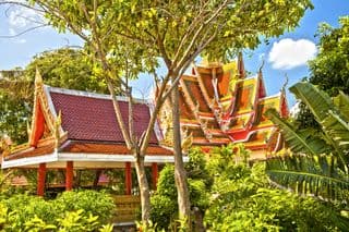 Traditional Thai Buddhist Temple amidst Tropical Greenery