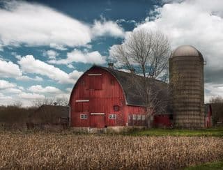 A Rustic Red Barn amidst Harvest Fields
