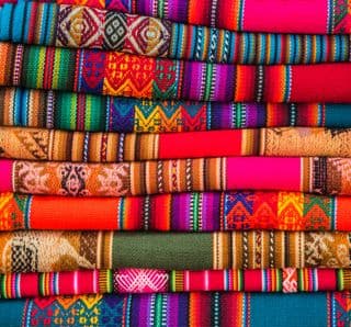 Stack of Vividly Colored Andean Textiles