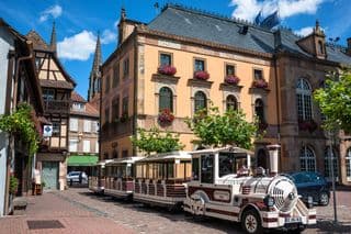 Obernai Excursion Train Amidst Historical Architecture