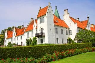 Elegant White Castle amidst Blooming Roses