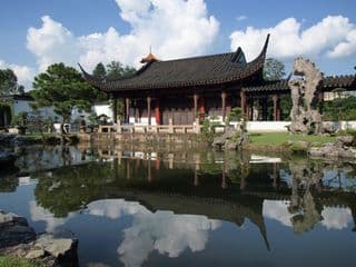 Ancient Chinese Pavilion amidst Tranquil Pond Reflection