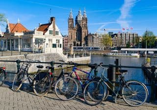 Bicycles in Amsterdam against the Background of a Church and Canal