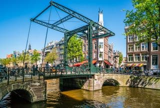 Bicyclists Crossing the Magere Brug in Amsterdam