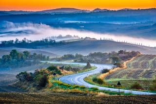 A Road Through the Tuscan Hills at Dawn