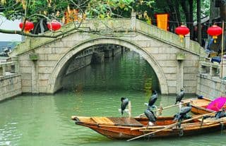 Ancient Stone Bridge Over Calm Canal in Water Village Tongli, Shanghai, China