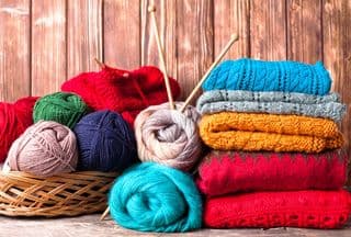 Colorful Knitted Garments and Yarn Balls