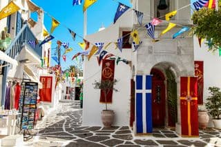 Celebratory Flags Over Mykonian Alleyway