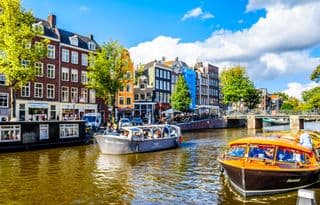 Amsterdam's Prince Canal Barges Under Blue Skies