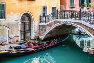 Gondolier Resting Under the Bridge in Venice