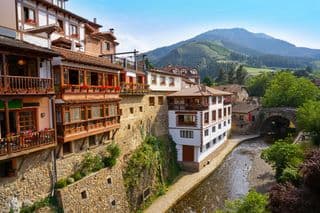 Traditional Village Houses by River in Cantabria, Spain