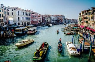Venice's Grand Canal Thrive with Boats and Passengers