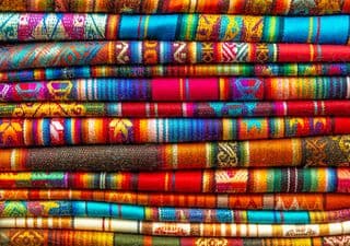 Stack of Vibrant Handwoven Textiles from the Andes