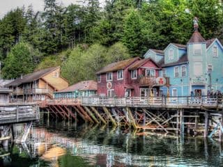 Stilted Buildings Amidst Alaska's Lush Forest