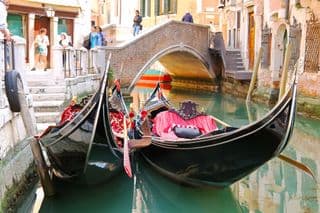 Gondolas Moored Along Venetian Canal