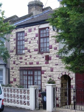 Stoneclad House with Red Window Frames