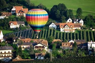 Colorful Hot Air Balloon Floating Over Austrian Village