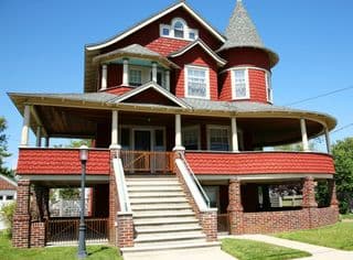 Red Victorian Mansion with Wraparound Porch