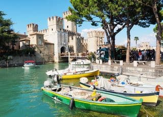 Castello di Sirmione: Boats in the Dock by Medieval Fortress