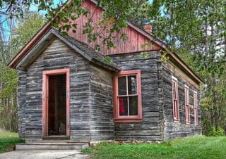 Weathered Log Cabin in Autumn Forest