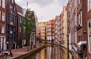 Reflections of Amsterdam's Architecture along the Canal