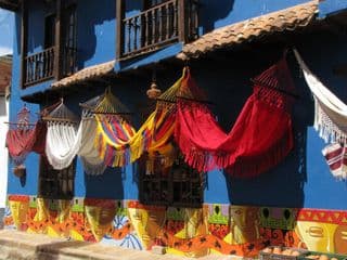 Vibrant Colombian Hammocks Displayed Against Blue Wall