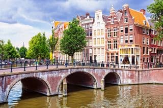 Tall Dutch Buildings Along Canal in Amsterdam