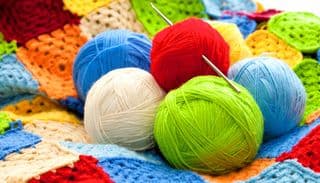 Vibrant Yarn Balls and Crocheted Afghan