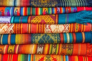 Stack of Vibrant Andean Woven Throws