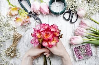 Hands Assembling a Vibrant Bouquet