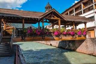 Flower-Adorned Wooden Bridge Over the Arve River in Chamonix