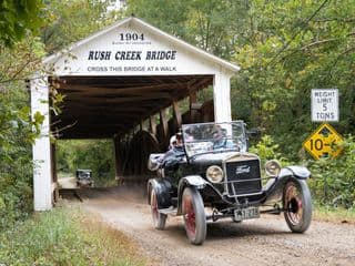 Vintage Ford Model T Driving Across Rush Creek Covered Bridge