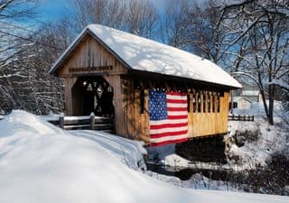 Snow-Covered Covered Bridge with American Flag