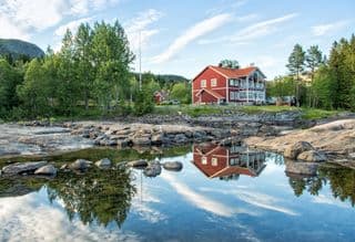 Traditional Swedish Cottage by the Rocky Shore