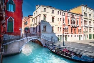 Gondolas Docked at an Arched Bridge in Venice