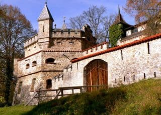 Medieval Fortress amidst Autumnal Forest