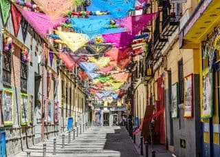 Colorful Fiesta Decorations in Madrid's Alleyway