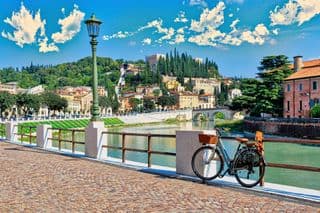 Bicycle Leaning Against the Adige River Bridge in Verona, Italy