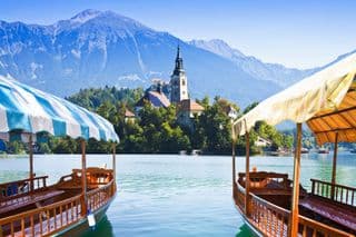 Traditional Pletna Boats at Lake Bled Island Church