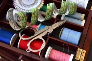 Vintage Scissors Among Thread Spools
