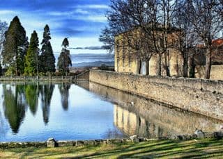 Ancient Stone Wall Reflecting in Pond