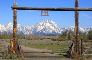 Ranch Entrance Amidst Majestic Mountains