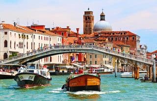 Venice's Grand Canal Thrive with Boats Under the Ponte degli Scalzi