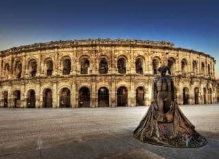 Statue of Torero in Front of an Ancient Roman Amphitheater