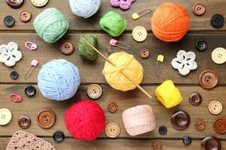 Assorted Yarn Balls and Crochet Hook