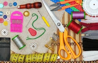 Assorted Sewing Tools Arrayed on Bamboo Mat