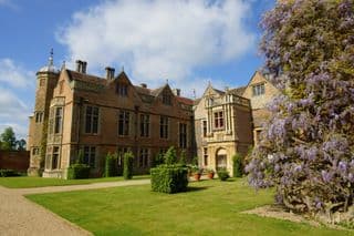 Charlecote Park: A Tudor Manor House amidst Blooming Wisteria